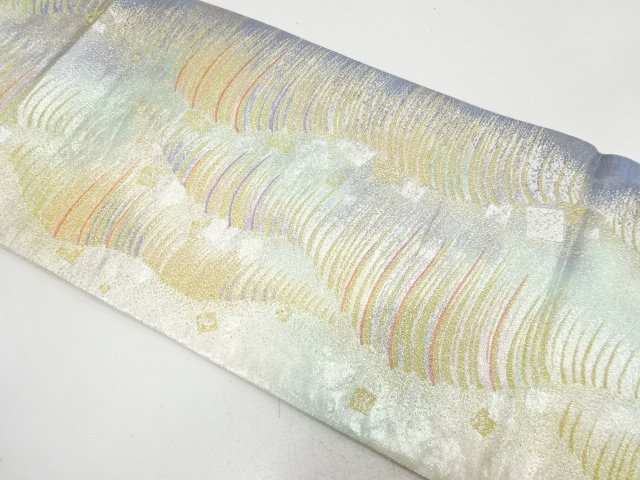 Bag belt with abstract wavy pattern woven into a scattering of foil
